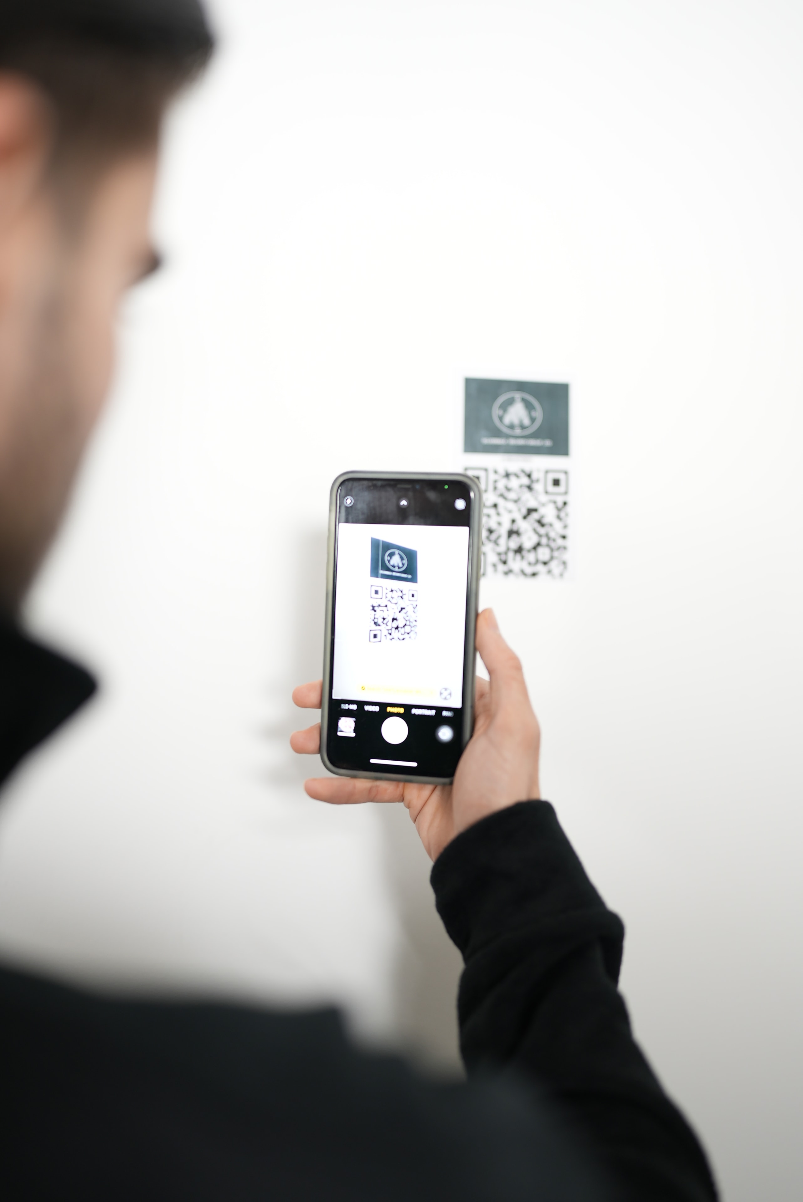 Guard scanning QR code checkpoint with smartphone